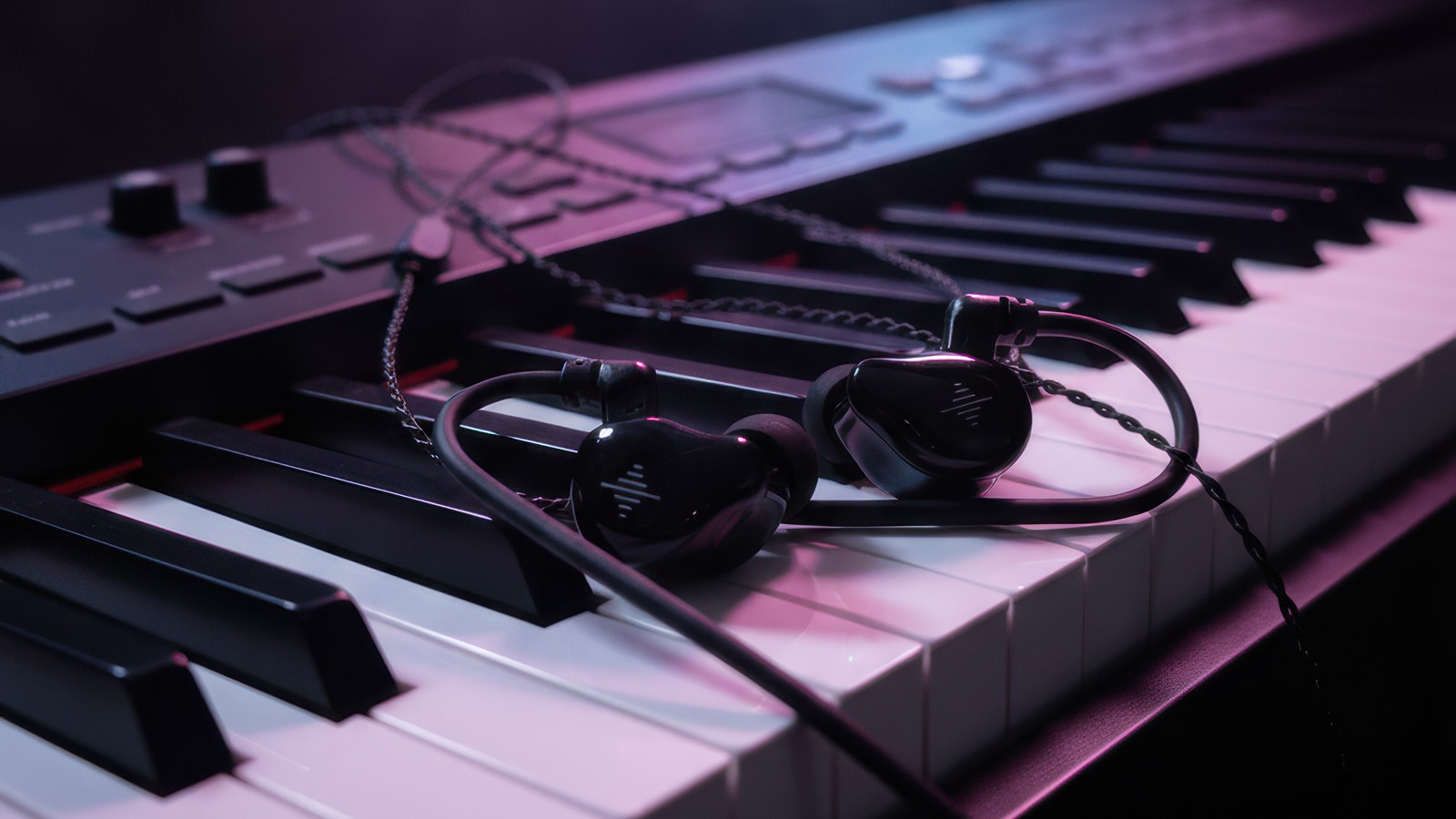 Soundbrenner Wave in-ear monitors on a piano
