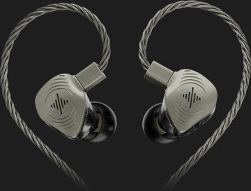 Paio di monitor in-ear argentati con cavi intrecciati su sfondo scuro