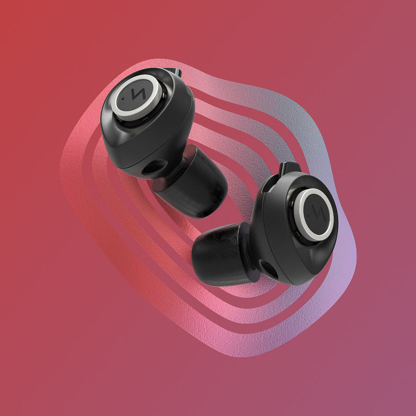 Pair of black earbuds on a pink and purple abstract background
