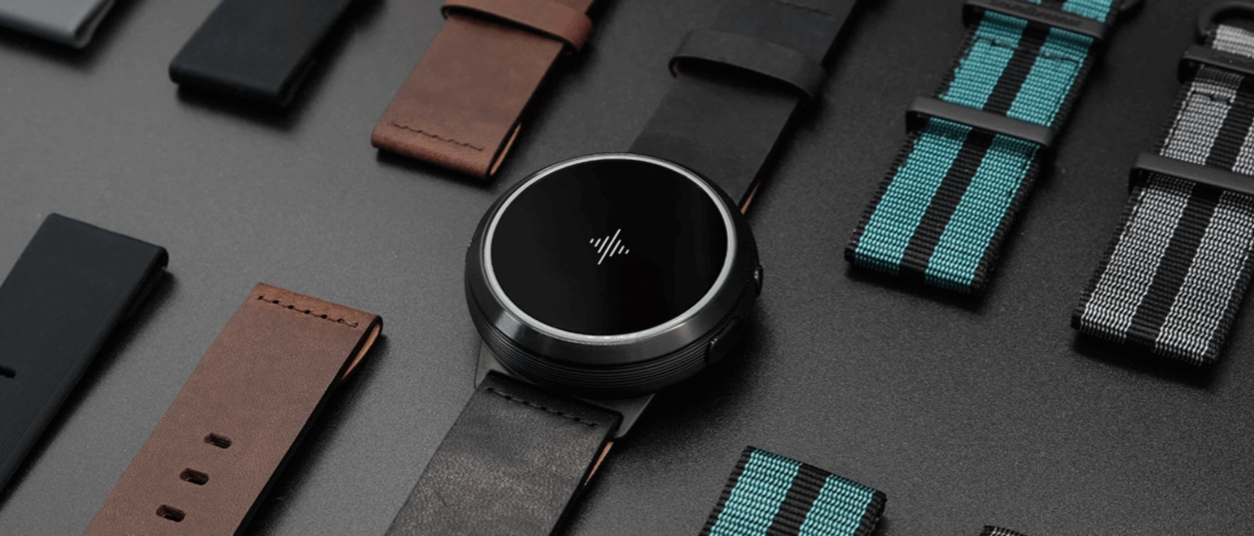 Round smartwatch surrounded by black, brown, and striped replacement bands
