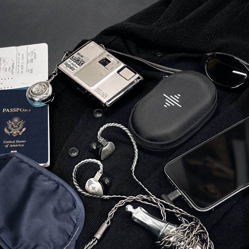 Wave Pro 2 in-ear monitors and carrying case with travel essentials at the airport