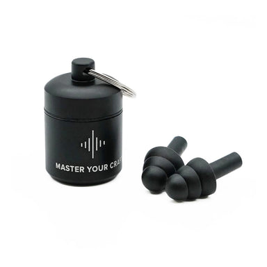 Black earplugs beside their cylindrical storage case