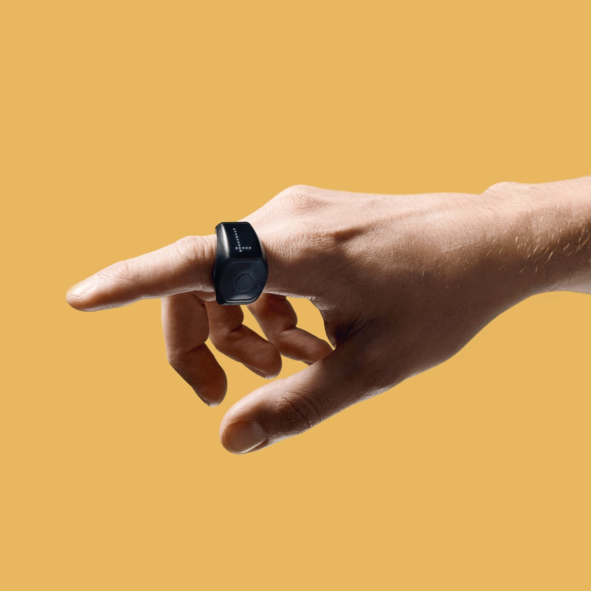 Black Genki Wave MIDI ring worn on an outstretched finger against a yellow background