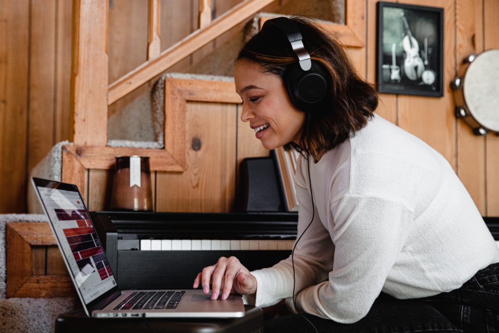 Soundbrenner - Girl on her laptop producing music
