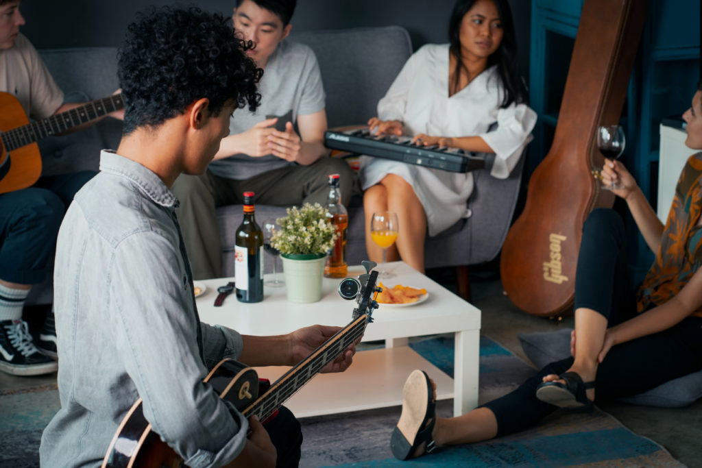Group of friends hanging out with instruments