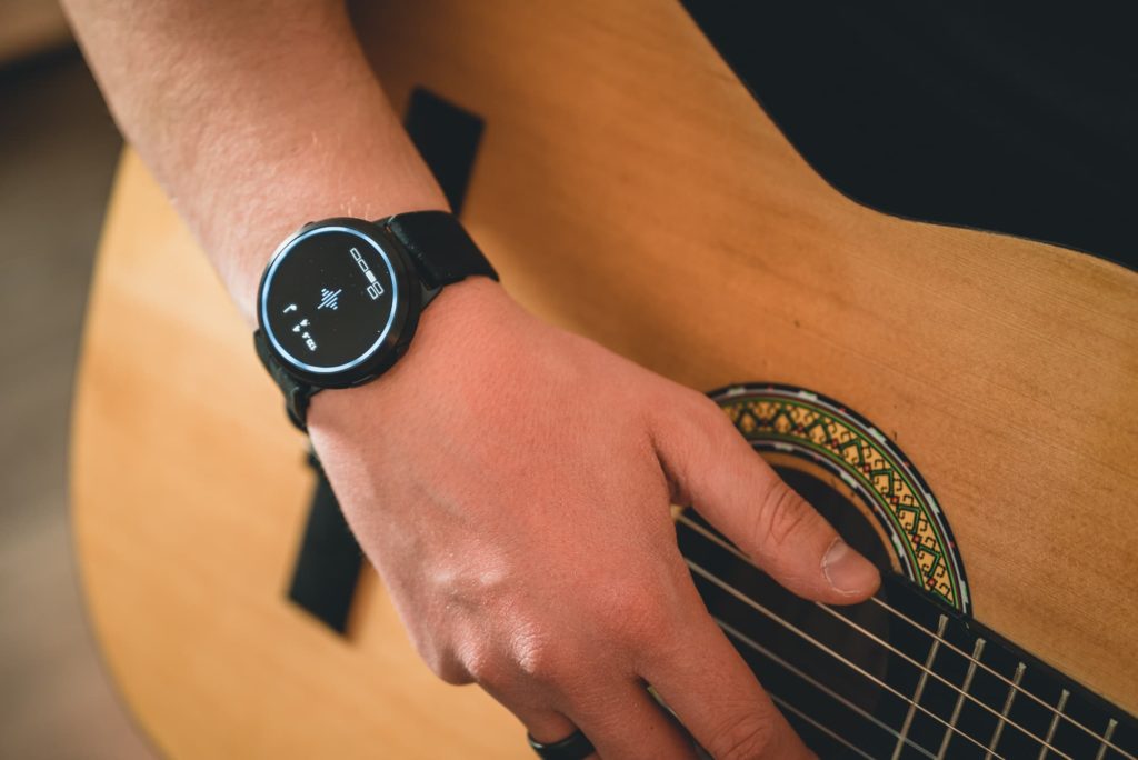 man wearing soundbrenner core plays the guitar